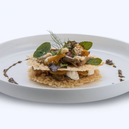 Parmesan cheese millefeuille served with a vegetable brunoise and a basil, rustic tomato and Calabrian black olive sauce
