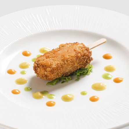 Mini fried salt cod mousse on sticks with rustic tomatoes served with a bell pepper and courgette sauce
